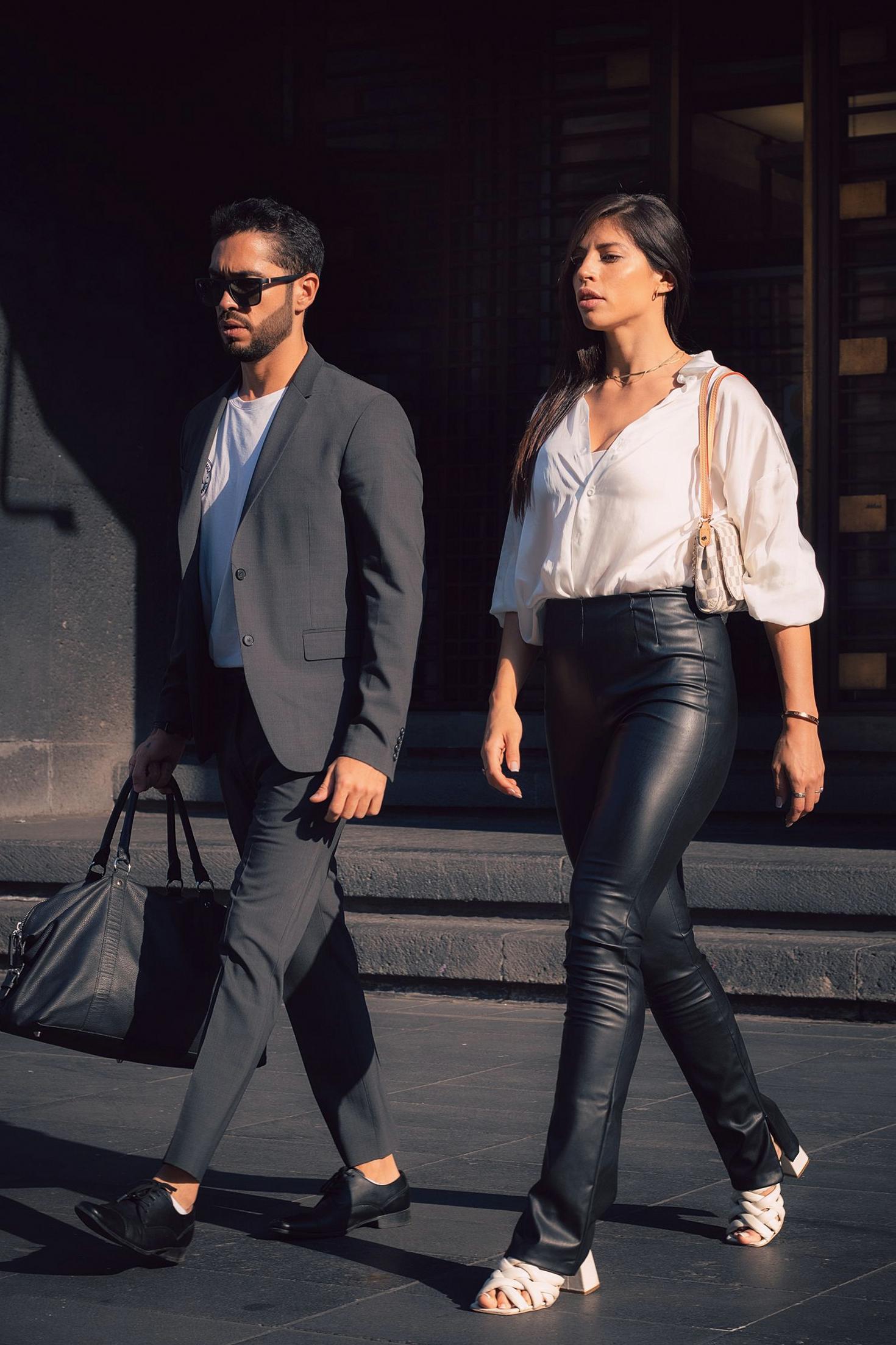 Couple in elegant suits walking outdoors
